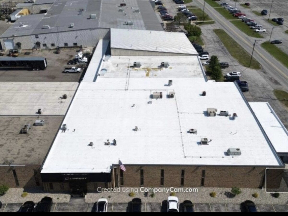 Aerial view of completed bright white industrial warehouse roof by Pioneer