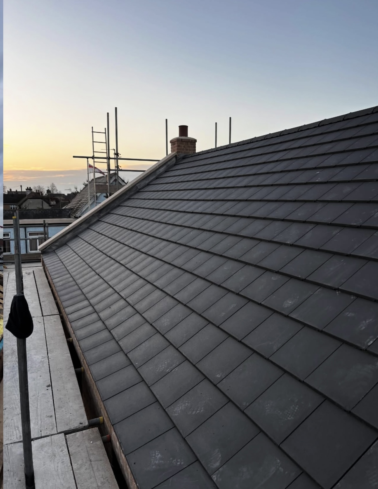 Completed slate-style tile roof on a steep-slope building installed by Pioneer Roofing